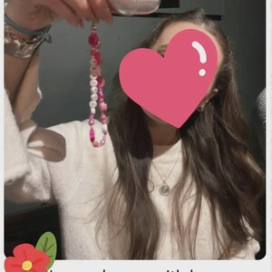 Handmade pink phone charm that is fully customisable. Each pink Y2K phone charm is made from upcycled pink beads, personalised with your name. Each custom phone charm is unique and makes a great gift for her, perfect for the Y2K trend. The pink phone straps are super cute and personalised, making a great Y2K phone accessory. The beaded pink phone wristlet is a great Y2K phone charm for any pink lover.