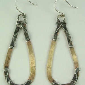 Hand-hammered brass teardrops w/ sterling filigree and sterling earwires.