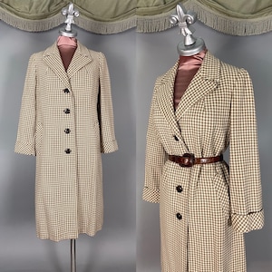 May include: A vintage houndstooth coat in brown and cream, displayed on a mannequin. The coat features a classic notched collar, button closures, and a tailored fit. The second image shows the coat with a brown belt. The coat's length is mid-calf.