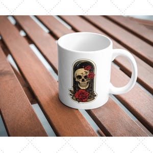 May include: White ceramic mug with a skull and red roses inside a glass dome design.