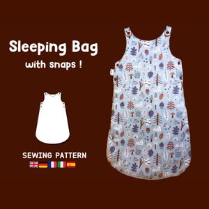 May include: A sewing pattern for a sleeping bag with snaps. The pattern is for a light blue sleeping bag with a woodland print featuring trees, mushrooms, and leaves. The pattern is available in English, French, German, Spanish, and Italian.