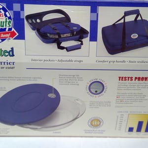 May include: An insulated food carrier box with the brand name "OVATIONS Carry-Outs". The box features images of a blue food carrier with interior pockets and adjustable straps, and a blue carrier with a comfort grip handle. The text reads "Keeps food hot or cold!"