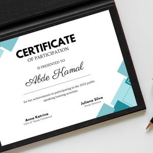 May include: A certificate of participation is presented to Abde Kamal for her achievements in participating in the 2022 public speaking training activities. The certificate features a blue and teal geometric design.