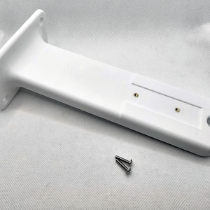 May include: White plastic mounting bracket with two screw holes and a slot for a cable. Two silver screws are included.