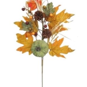 May include: A fall-themed floral stem featuring a green pumpkin, maple leaves in shades of yellow and orange, brown pinecones, and small red berries. The arrangement is set against a white background.