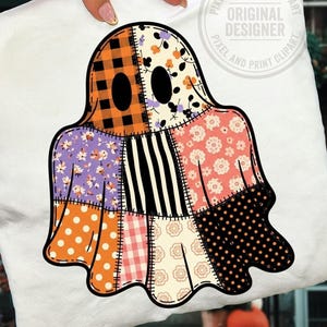 May include: A white t-shirt featuring a large ghost graphic composed of various patchwork patterns including orange plaid, floral prints, black and white stripes, polka dots, and gingham. The ghost has two solid black oval eyes and a thick black outline.