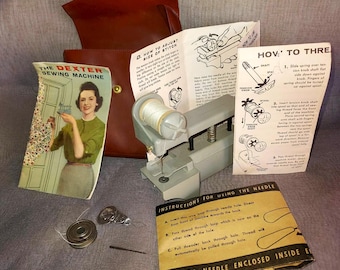 Vintage 1950&#39;s The Dexter Sewing machine handheld with case, paper work and extra parts