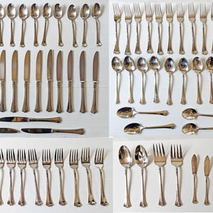 May include: A set of silverware in a silver finish. The set includes forks, knives, spoons, and serving pieces.