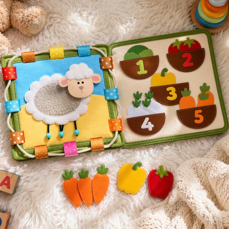 May include: A colorful felt activity book for toddlers. The open book displays a sheep scene and a counting page with vegetables. Includes felt carrots, a yellow pepper, and a red tomato. The book is designed with bright colors and soft textures.