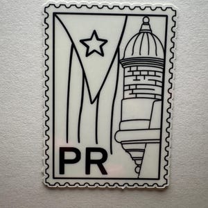 May include: A white sticker with a black outline, featuring a design of the Puerto Rican flag and a building with a dome. The letters "PR" are at the bottom. The sticker has a postage stamp edge.