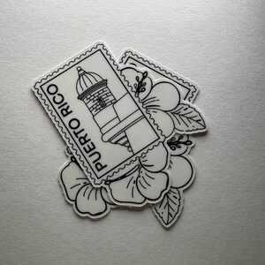 May include: White stickers featuring a lighthouse design within a postage stamp frame, with the text "PUERTO RICO". The stickers are layered over black and white floral illustrations.