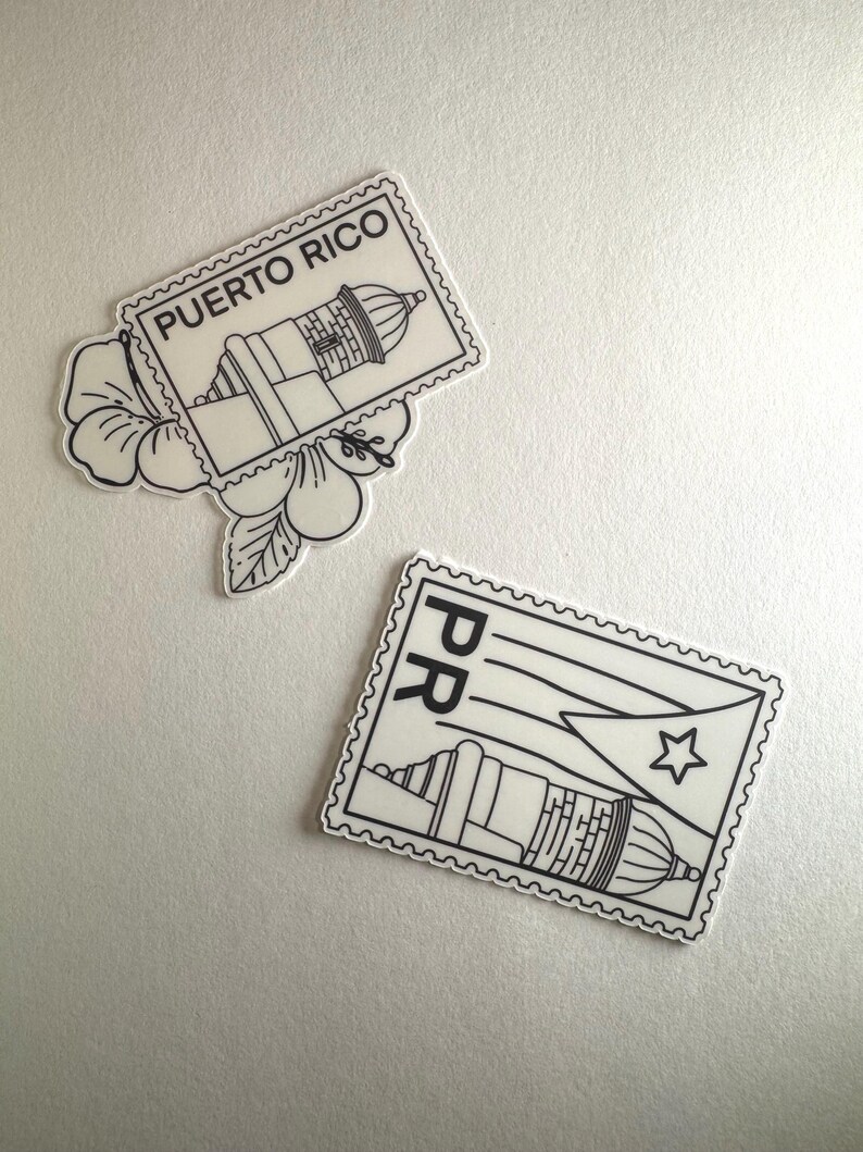 May include: Two white and black stickers with a Puerto Rico theme. One sticker is shaped like a postage stamp with the text "PUERTO RICO" and an image of a lighthouse. The other sticker has the Puerto Rican flag and a lighthouse.