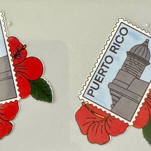 May include: Two decorative stickers featuring a Puerto Rico postage stamp design with a gray building and the text "PUERTO RICO". Each stamp is paired with a red hibiscus flower and green leaf.