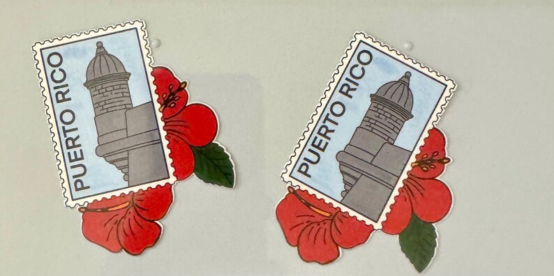May include: Two decorative stickers featuring a Puerto Rico postage stamp design with a gray building and the text "PUERTO RICO". Each stamp is paired with a red hibiscus flower and green leaf.