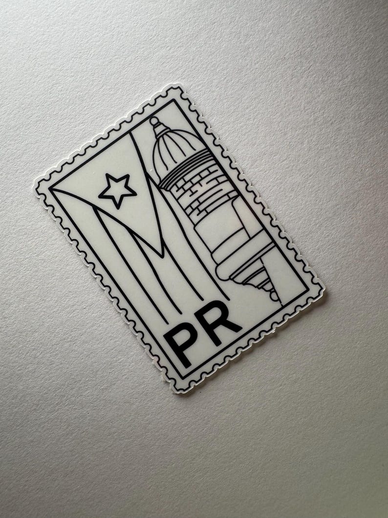 May include: A black and white sticker in the shape of a postage stamp. The sticker features the flag of Puerto Rico, a building, and the letters "PR". The sticker has a scalloped edge.