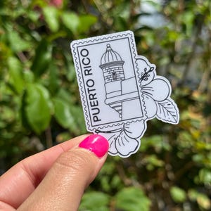 May include: A black and white sticker featuring a Puerto Rico stamp design with a building and the text "PUERTO RICO". The sticker is in the shape of a stamp and a flower.