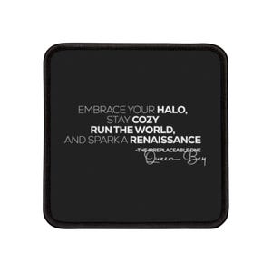 May include: Black square coaster with a stitched border. The coaster features white text that reads "EMBRACE YOUR HALO, STAY COZY, RUN THE WORLD, AND SPARK A RENAISSANCE." Below the text is "-THEIRREPLACEABLE ONE" and the signature "Queen Bey."