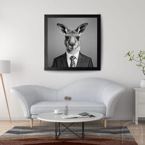 May include: A black and white photograph of a kangaroo wearing a suit and tie. The kangaroo is looking directly at the camera. The background is a plain grey.