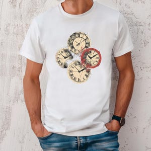 May include: White t-shirt with a graphic of four vintage clocks with Roman numerals. The clocks are layered on top of each other and have a distressed look.