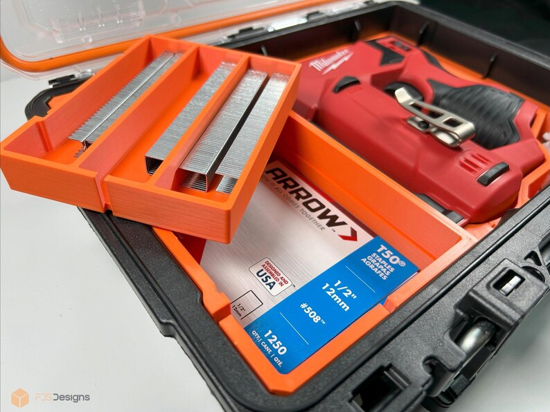 May include: An orange plastic storage case with a red and black electric staple gun and a pack of 1/2 inch staples. The staples are labeled "Arrow" and "T50".