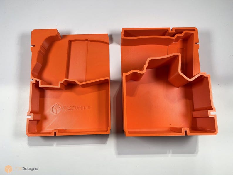 May include: Two orange plastic storage boxes with custom cutouts for holding tools. The boxes are open and show the interior cutouts. The box on the left has the text "F&S Designs" printed on the bottom.