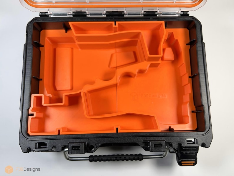 May include: An open black and orange tool case with a custom foam insert. The foam insert has a cutout for a power tool.