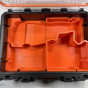 May include: An orange foam insert for a black tool case. The insert has two compartments, one larger than the other. The insert is labeled "Foxfire Designs".