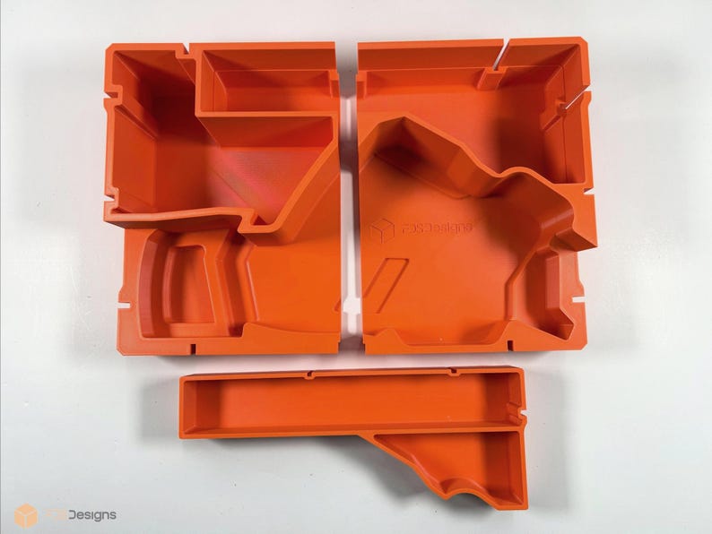 May include: Orange plastic storage organizer with multiple compartments. The organizer is divided into three sections, each with a different shape. The organizer is designed to hold small items, such as tools, craft supplies, or electronics.