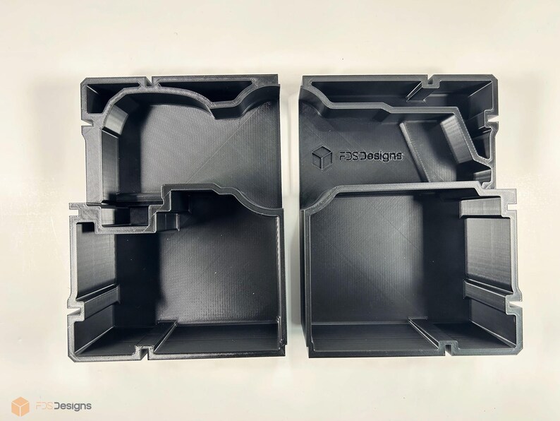 May include: Two black plastic storage boxes with compartments. The boxes are designed to hold small items and have the text "FDS Designs" printed on the side.