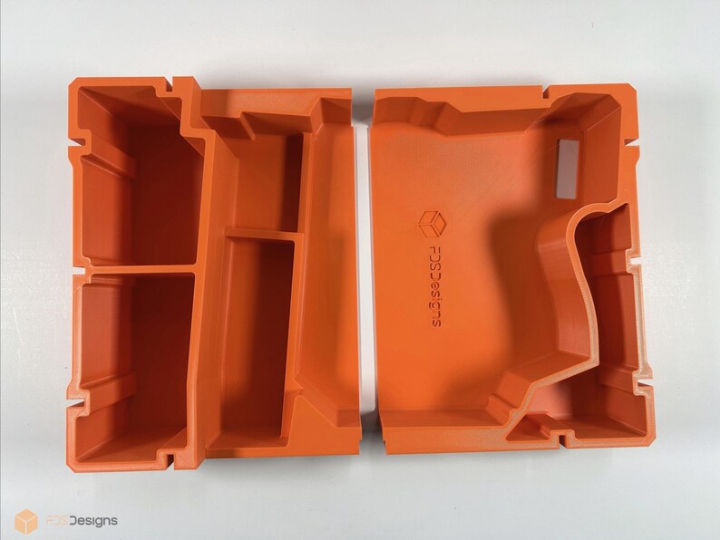 May include: Two orange plastic storage containers with compartments. The container on the right has the text "FDC3D3SIGNS" printed on the side.