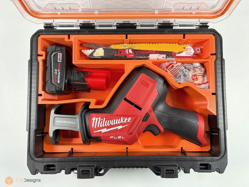 May include: A red and black Milwaukee FUEL reciprocating saw with a black and gray Hackzall blade, a red M12 REDLITHIUM XC 4.0 battery, and a variety of saw blades in a black and orange hard case.
