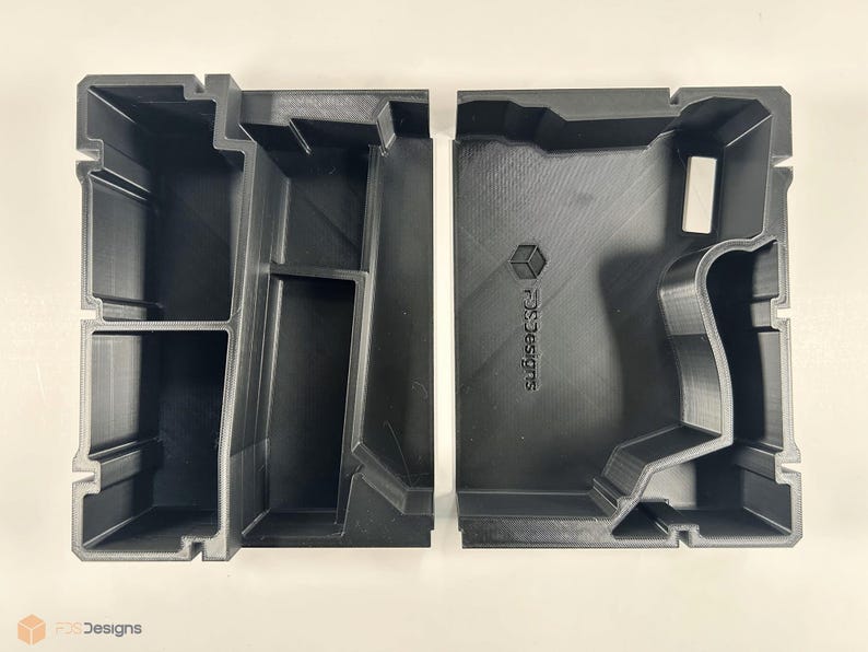 May include: Two black plastic storage boxes with compartments. The box on the right has the text "Subcase Designs" printed on the side.