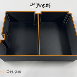 May include: A black rectangular storage container with an orange trim and two compartments. The text "2X (Depth)" is at the top. The logo "FDS Designs" is at the bottom.