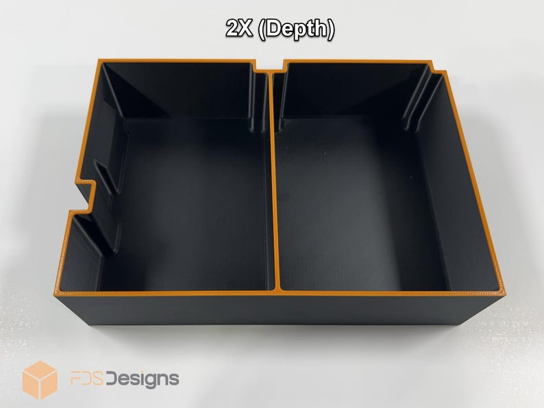 May include: A black rectangular storage container with an orange trim and two compartments. The text "2X (Depth)" is at the top. The logo "FDS Designs" is at the bottom.