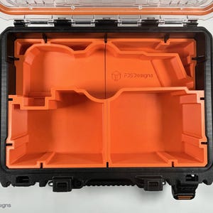 May include: An open black and orange hard case with a foam insert. The insert has two compartments with custom cutouts. The case has a label that reads "FCS Designs".