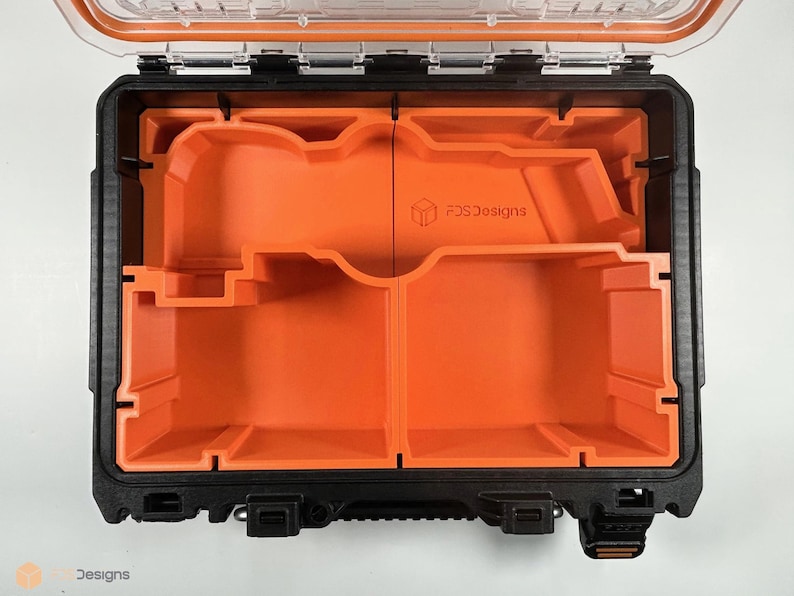May include: An open black and orange hard case with a foam insert. The insert has two compartments with custom cutouts. The case has a label that reads "FCS Designs".