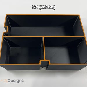 May include: A black and orange organizer with three compartments. The organizer has a rectangular shape with a textured surface. The text "3X (Width)" is at the top. The logo "FDS Designs" is at the bottom.