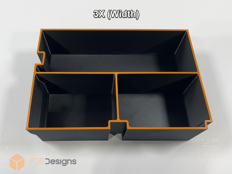 May include: A black and orange organizer with three compartments. The organizer has a rectangular shape with a textured surface. The text "3X (Width)" is at the top. The logo "FDS Designs" is at the bottom.