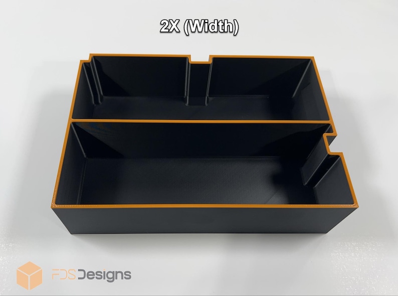 May include: Black storage organizer with orange trim, featuring two compartments and a stepped design. The text "2X (Width)" is visible at the top. The product is from FDS Designs.