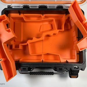 May include: An orange and black tool box with a removable foam insert. The insert has multiple compartments for organizing tools.