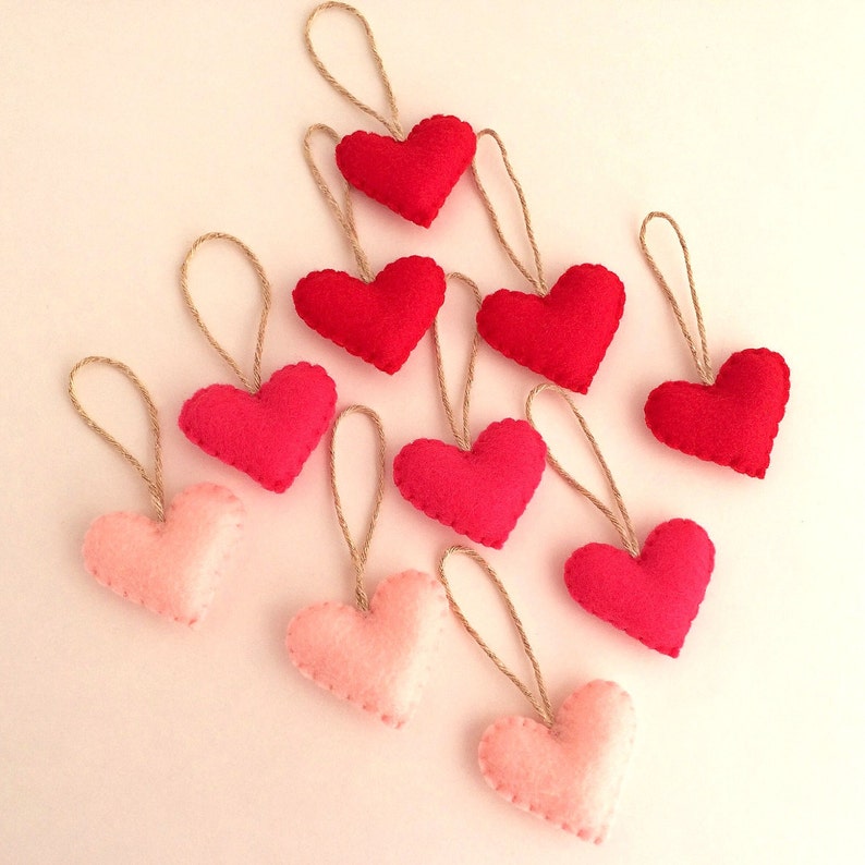 May include: A set of ten felt heart ornaments, five pink and five red, with twine string for hanging.