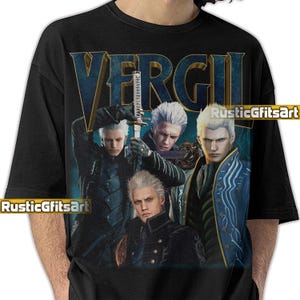 May include: Black t-shirt featuring a graphic of a character with white hair and a sword, with the name "VERGIL" in blue and gold lettering. The design includes multiple images of the character. The text "RusticGfitsArt" is also visible.