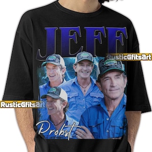 May include: Black t-shirt featuring a graphic of Jeff Probst with the name "JEFF" in large blue letters. The design includes multiple images of Jeff wearing a blue shirt and a hat. The word "Probst" is written in script.