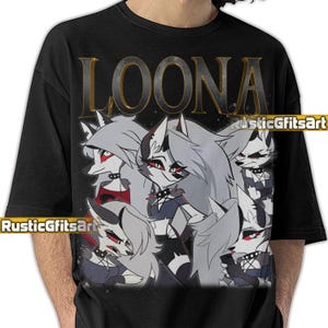May include: Black t-shirt featuring a graphic of Loona, a cartoon character with gray fur, red eyes, and a black choker. The word "LOONA" is printed in gold letters at the top. The shirt has the text "RusticGiftsArt" printed on it.