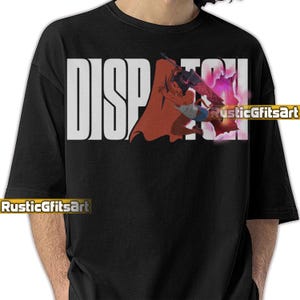 May include: Black crew neck t-shirt featuring the word "DISPATCH" in large white letters. A graphic of a person with a sword and cape is on the right. The text "RusticGiftsArt" is at the bottom of the shirt.