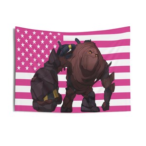 May include: A tapestry featuring a pink and white American flag design with a cartoon illustration of a brown, armored creature. The creature has yellow eyes and is set against the flag's stripes and stars.