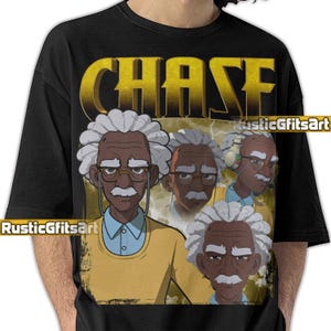 May include: Black t-shirt featuring a cartoon illustration of an elderly man with glasses and a white mustache. The word "CHASE" is printed in gold above the illustration. The shirt also has the text "RusticGfitsArt".