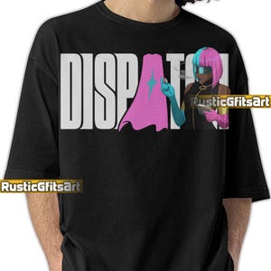 May include: Black crew neck t-shirt with the word "DISPATCH" in large white block letters. A graphic of a person with pink and blue hair, a cape, and a cigarette is on the right. The artist's name, "RusticGfitsArt", is at the bottom.
