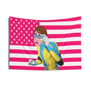 May include: A tapestry featuring an illustration of a person wearing goggles and a yellow and blue suit, set against a pink and white American flag. The person appears surprised, with one hand raised.