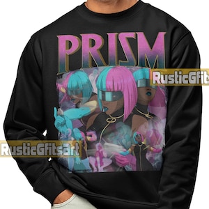 May include: Black sweatshirt featuring a graphic of three figures with pink and blue hair, wearing futuristic eyewear. The word "PRISM" is printed above the graphic in a gradient font. The sweatshirt is a crew neck style.